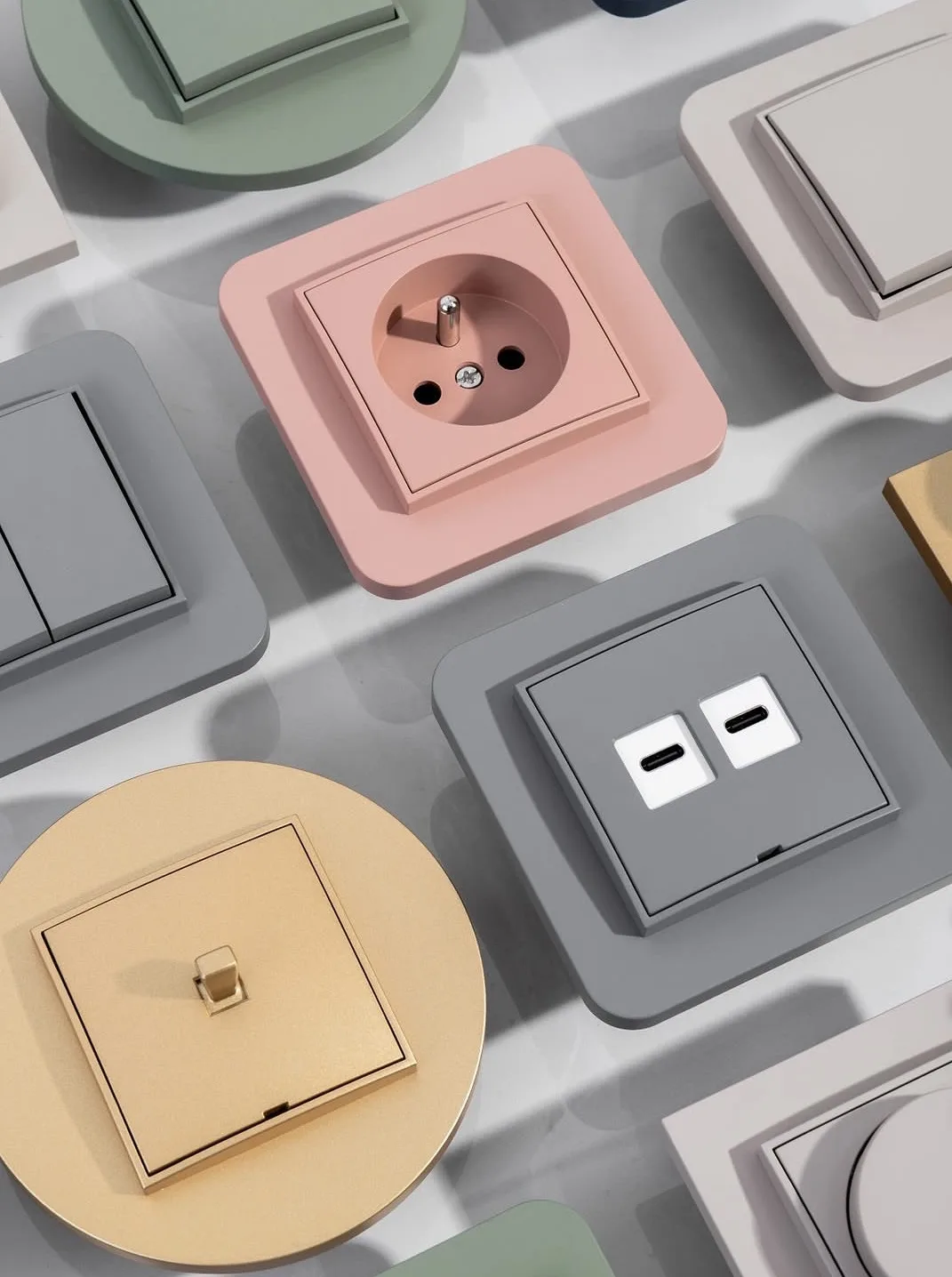 Karlik MINI switches and sockets in sage, pink, grey, gold and taupe